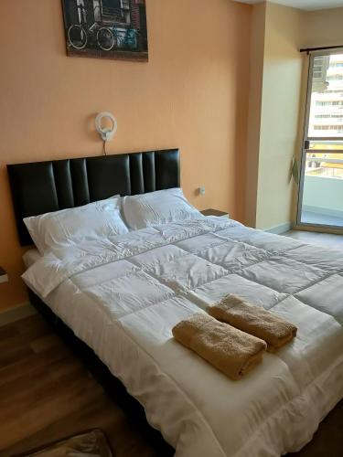 a large white bed with two pillows on it at View Talay 1B by Fernando in Pattaya South