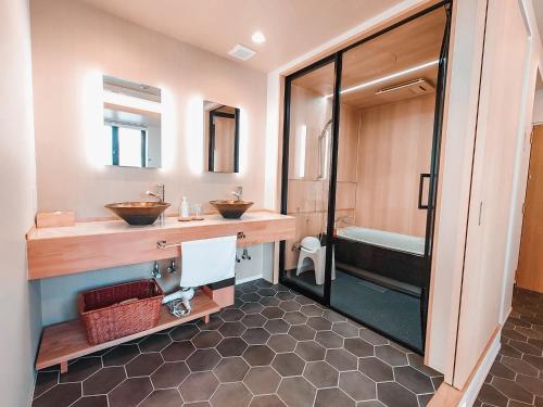 a bathroom with two sinks and a shower at Hotel Imagine Kyoto in Kyoto