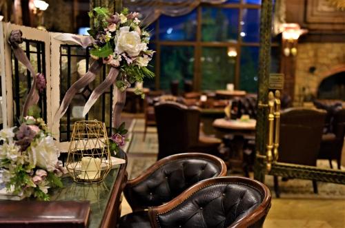a table with flowers on it in a restaurant at Maxi Park Hotel & Spa in Velingrad