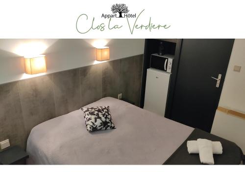 a bedroom with a bed with a pillow on it at Le Clos la Verdière in Velaux