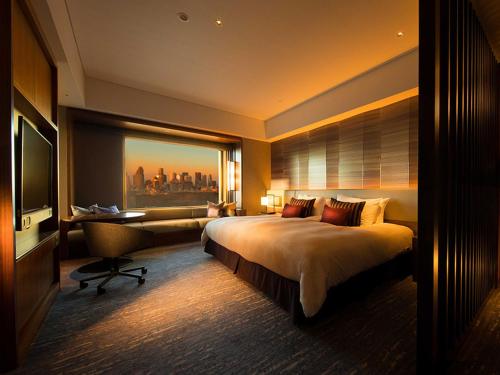 a hotel room with a large bed and a desk at Cerulean Tower Tokyu Hotel, A Pan Pacific Partner Hotel in Tokyo