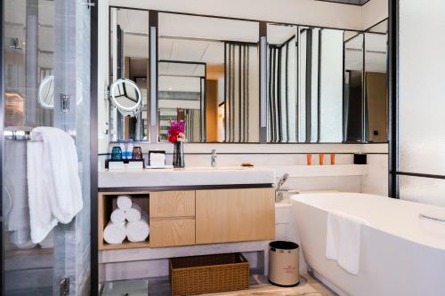 a bathroom with a sink and a large mirror at Crowne Plaza Shenzhen Nanshan by IHG in Shenzhen