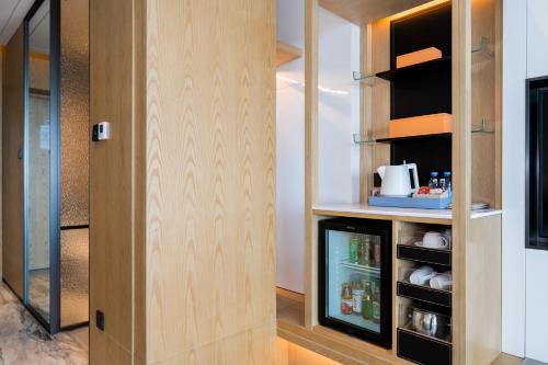 a walk in pantry with a door and a refrigerator at Crowne Plaza Shenzhen Nanshan by IHG in Shenzhen