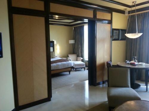 a bedroom with a bed and a living room at Blue Diamond Pune IHCL SeleQtions in Pune