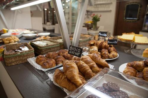 a bakery with a bunch of different types of pastries at Hotel Clelia in Deiva Marina