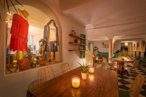 a dining room with a wooden table in a room at Villa Beldi in Essaouira