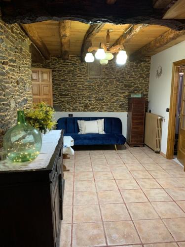 a living room with a blue couch in a room at Casa Ferreiro - Campo da Cruz - Lugo in Baltar