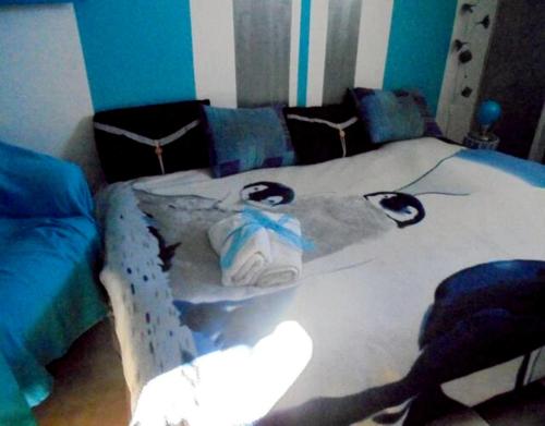 a living room with a bed and a couch at blue room, kitchenette in Chaumont