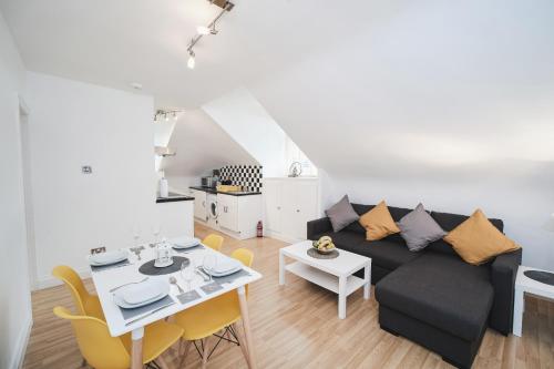 a living room with a couch and a table at Canterbury 2 Bed Apartment Close to Town CT1 Sleeps 6 in Canterbury