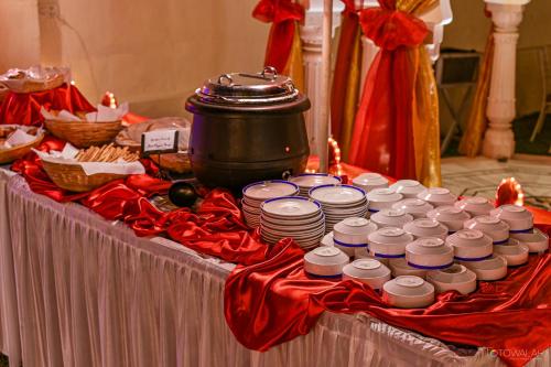 a table with a bunch of dishes and a pot at Hotel Castle Mandawa in Mandāwa