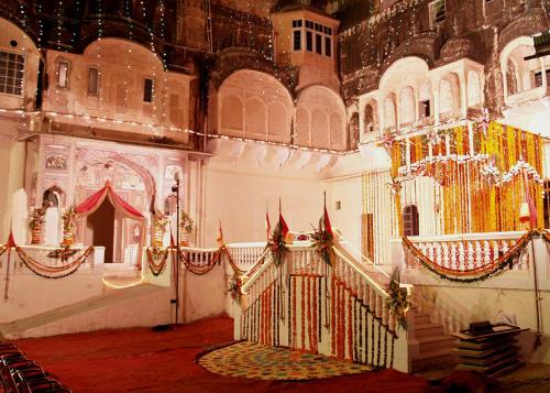 a room with a staircase in a building with flags at Hotel Castle Mandawa in Mandāwa