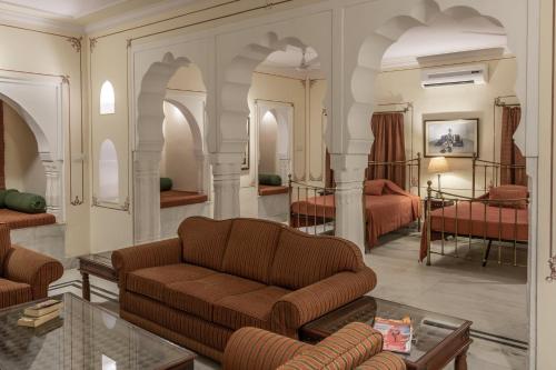 a living room with a couch and a bed at Hotel Castle Mandawa in Mandāwa