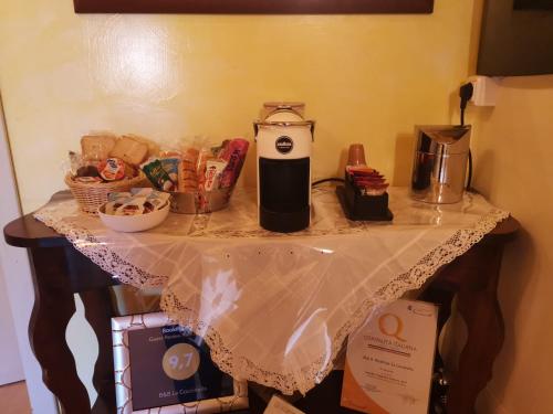 a table with a coffee maker and other items on it at B&B La Coccinella in Amaseno