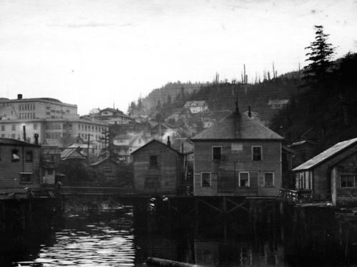 a black and white photo of a city with a river at Inn At Creek Street in Ketchikan