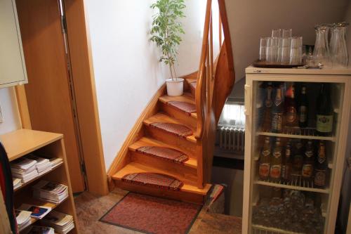 a hallway with a staircase with bottles of beer at Pension Becker in Rothenburg ob der Tauber
