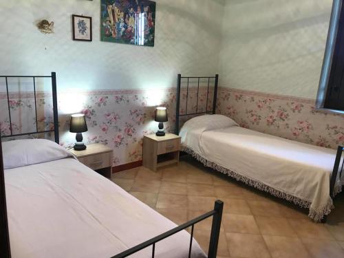 Postel nebo postele na pokoji v ubytování Villa Milici