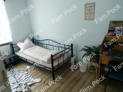 a room with a bed and a zebra print floor at Ferienhaus Mörterteich in Litschau