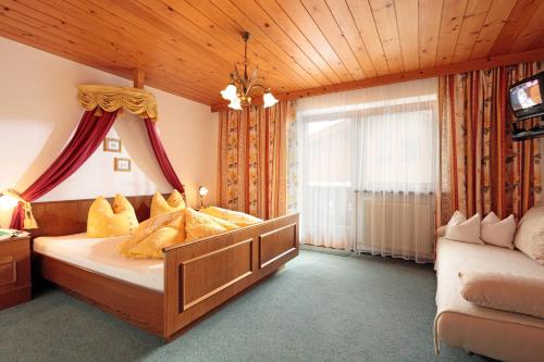 a bedroom with a bed with yellow pillows at Haus Schroll in Ried im Zillertal