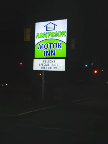 a sign for an indoor motor inn at night at Arnprior Motor Inn in Arnprior