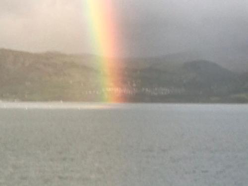 a rainbow over a body of water with a rainbow at Church Street Homestay in Beaumaris