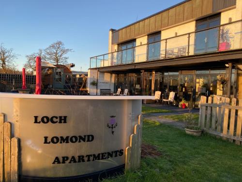 a building with a sign that reads lock london apartments at loch lomond apartments in Alexandria