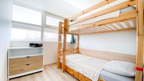 a bedroom with two bunk beds and a window at Vakantiewoning Kaviaar in Middelkerke