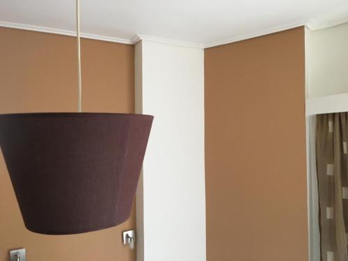 a black pendant light hanging in a room at Hotel George in Kalamata