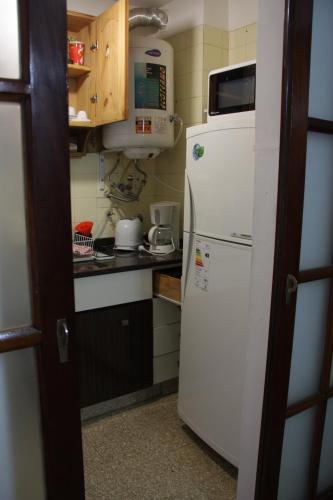 a kitchen with a white refrigerator in a kitchen at Departamento Yatay Corrientes in Buenos Aires