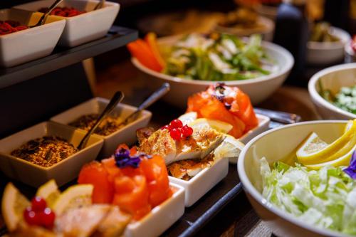 a table topped with bowls of different types of food at SCHUSTER Boarding House in Braşov