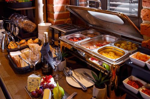 a buffet with a lot of food on a table at SCHUSTER Boarding House in Braşov