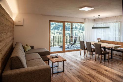 a living room with a couch and a table at Willmüllerhof in Perca