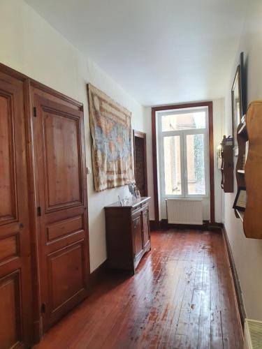 a room with a wooden floor and a door at Chateau de Bonnevaux in Villeneuve-de-Marc