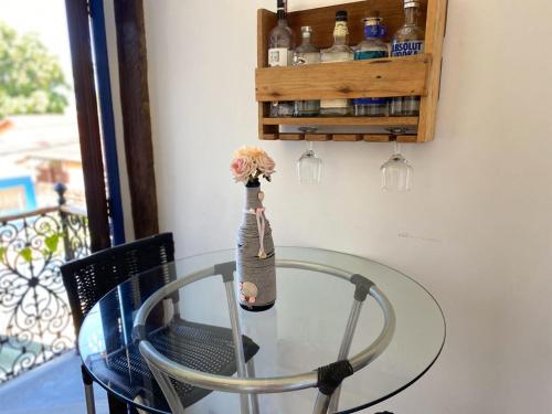 a glass table with a vase on top of it at Vila Pequeá Pousada Ilhabela in Ilhabela