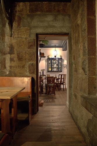 an open doorway to a dining room with a stone wall at Whitebridge Hotel in Whitebridge