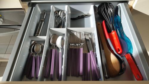 a drawer filled with utensils in a kitchen at SNP- PALMS in Papetoai