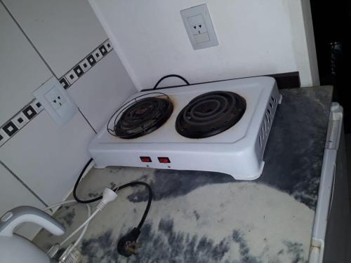 a white stove in a corner of a kitchen at CielosdeColon I in Colón