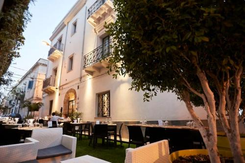 a restaurant with tables and chairs in front of a building at Il Vecchio Marsala in Marsala