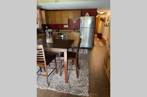 a kitchen with a table and a refrigerator at Best creek view and mountain view in town. Unbeatable location in Vail