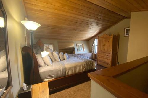 a bedroom with a bed and a wooden ceiling at Best creek view and mountain view in town. Unbeatable location in Vail