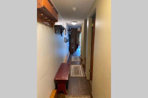 a hallway with a bench in a room with a hallway at Best creek view and mountain view in town. Unbeatable location in Vail