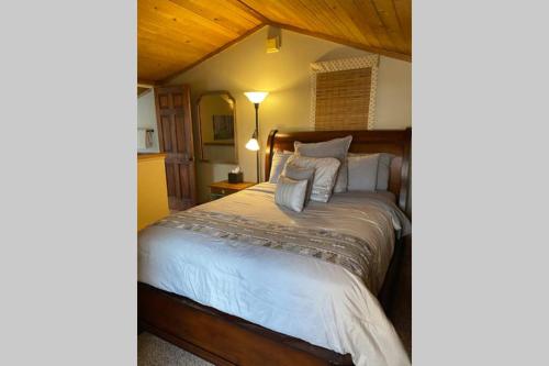 a bedroom with a bed with white sheets and pillows at Best creek view and mountain view in town. Unbeatable location in Vail