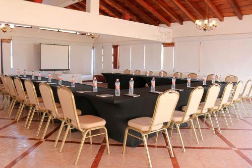 a long black table and chairs in a room at Hotel Agua Escondida in Taxco de Alarcón