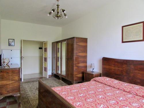 a bedroom with a bed and a dresser at Agriturismo "Borgo Madonna degli Angeli" - charming cottages in the gardens ! in Tocco da Casauria