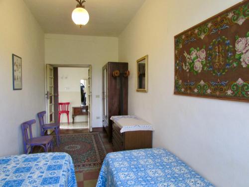 a bedroom with two beds and a painting on the wall at Agriturismo "Borgo Madonna degli Angeli" - charming cottages in the gardens ! in Tocco da Casauria