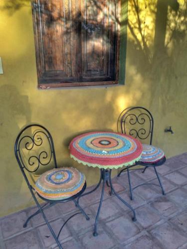 two chairs and a table with a rug on them at Chakana Hospedaje Rural in Villa Unión