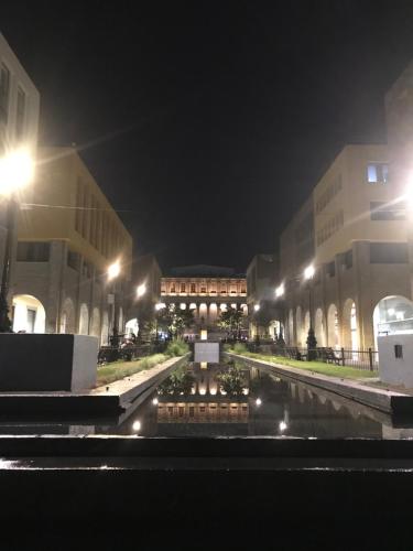 a city street at night with buildings and a fountain at Six Hotel Guadalajara Degollado in Guadalajara
