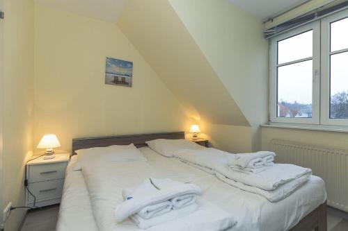 a bedroom with two beds with white towels on them at Strandschloesschen-Haus-II-WE-20-9720 in Kühlungsborn