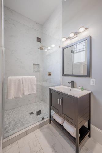 a bathroom with a sink and a shower at The George - Luxury Boutique Inn in Napa