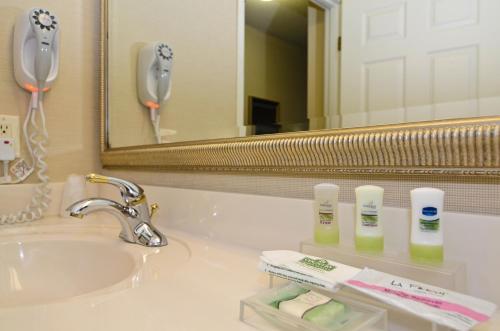 a bathroom with a sink and a mirror at Country Inn & Suites by Radisson, Stevens Point, WI in Stevens Point