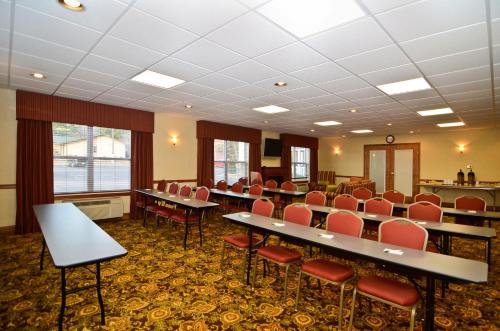 a conference room with tables and chairs in it at Country Inn & Suites by Radisson, Stevens Point, WI in Stevens Point